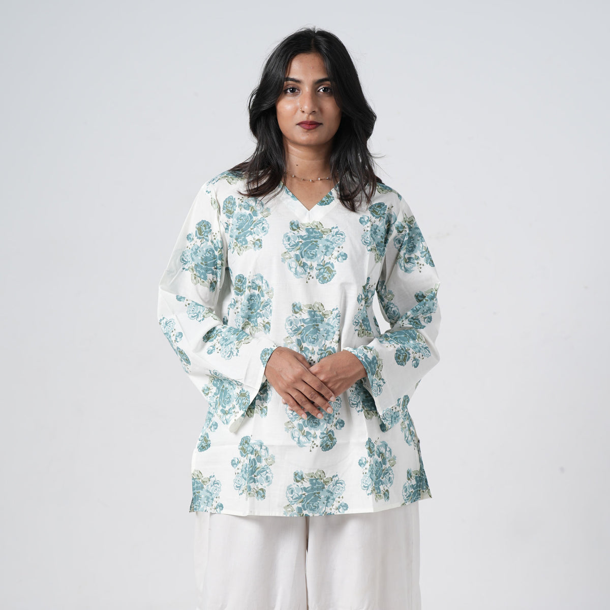 Aqua blue floral short kurti for women with blue rose prints on a white base