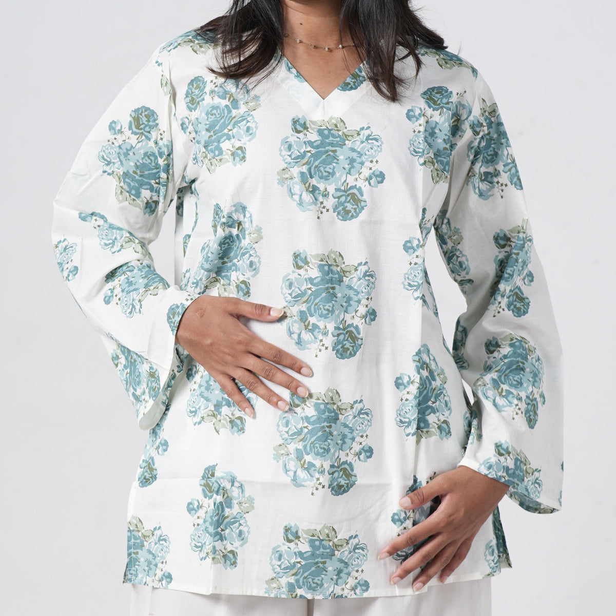 Aqua blue floral short kurti featuring a V neckline and blue rose patterns