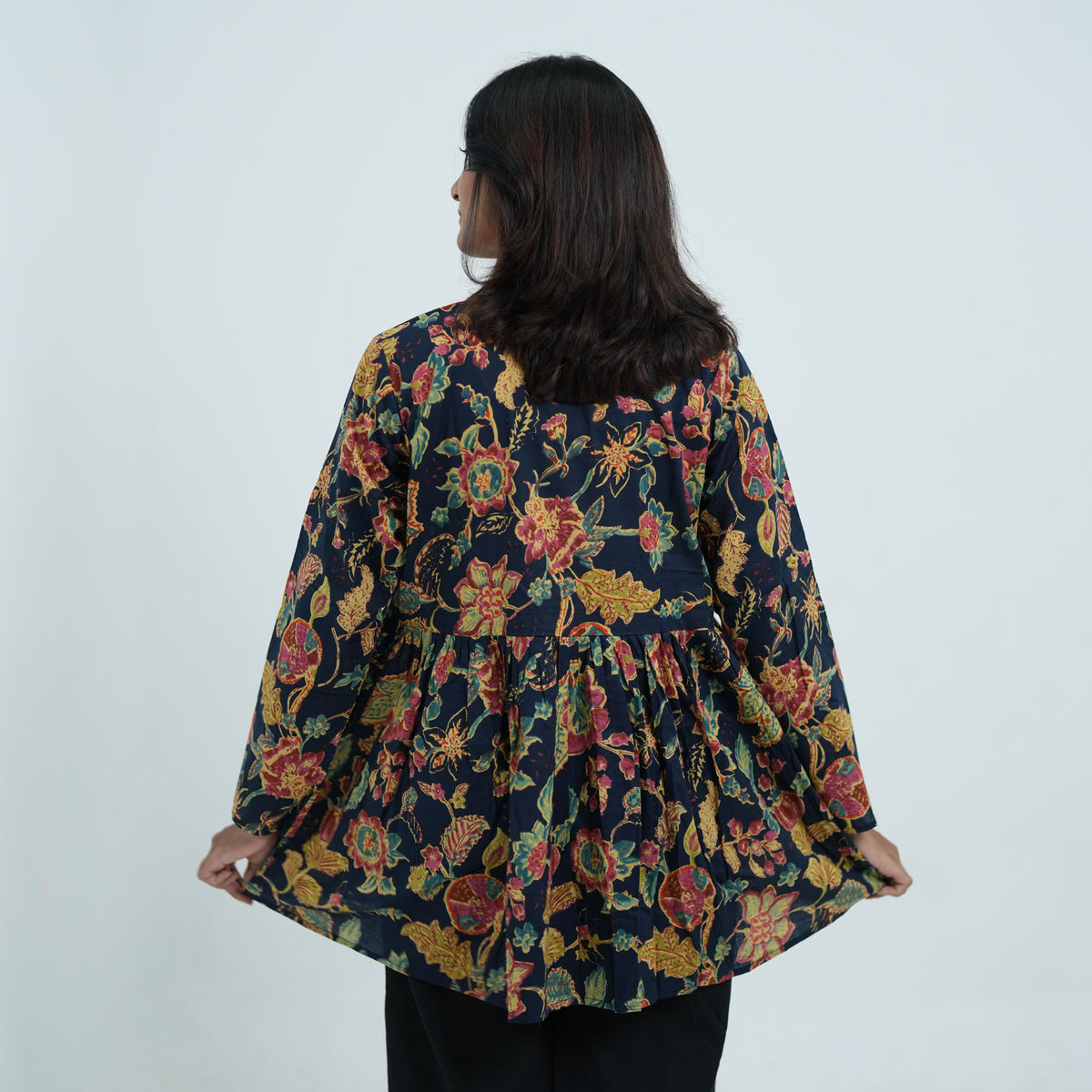 Back view of Arohi Garden Flared Kurti in navy blue with colourful floral prints and a flared design