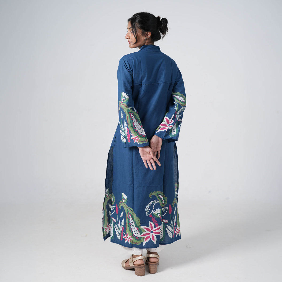 Back view of Boho Neel Long Kurti in blue with colourful floral prints along the hem and sleeves