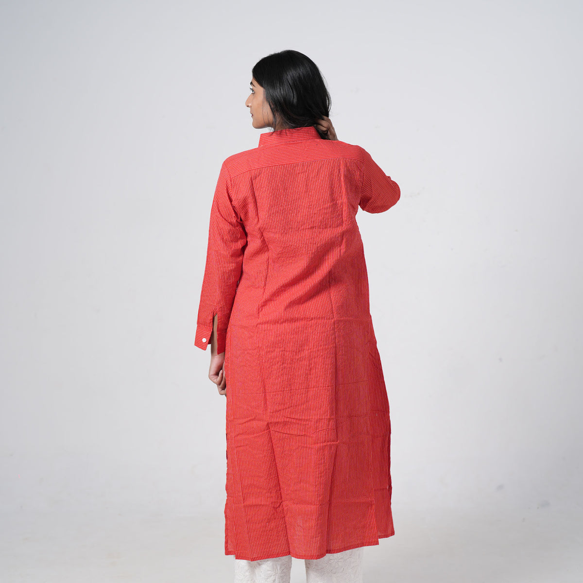 Back view of Coral Red Long Shirt featuring subtle vertical patterns and a relaxed longline silhouette