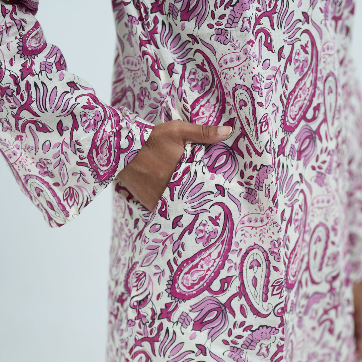 Gul Noor Knee Kurti in white with pink paisley prints and a pocket detail