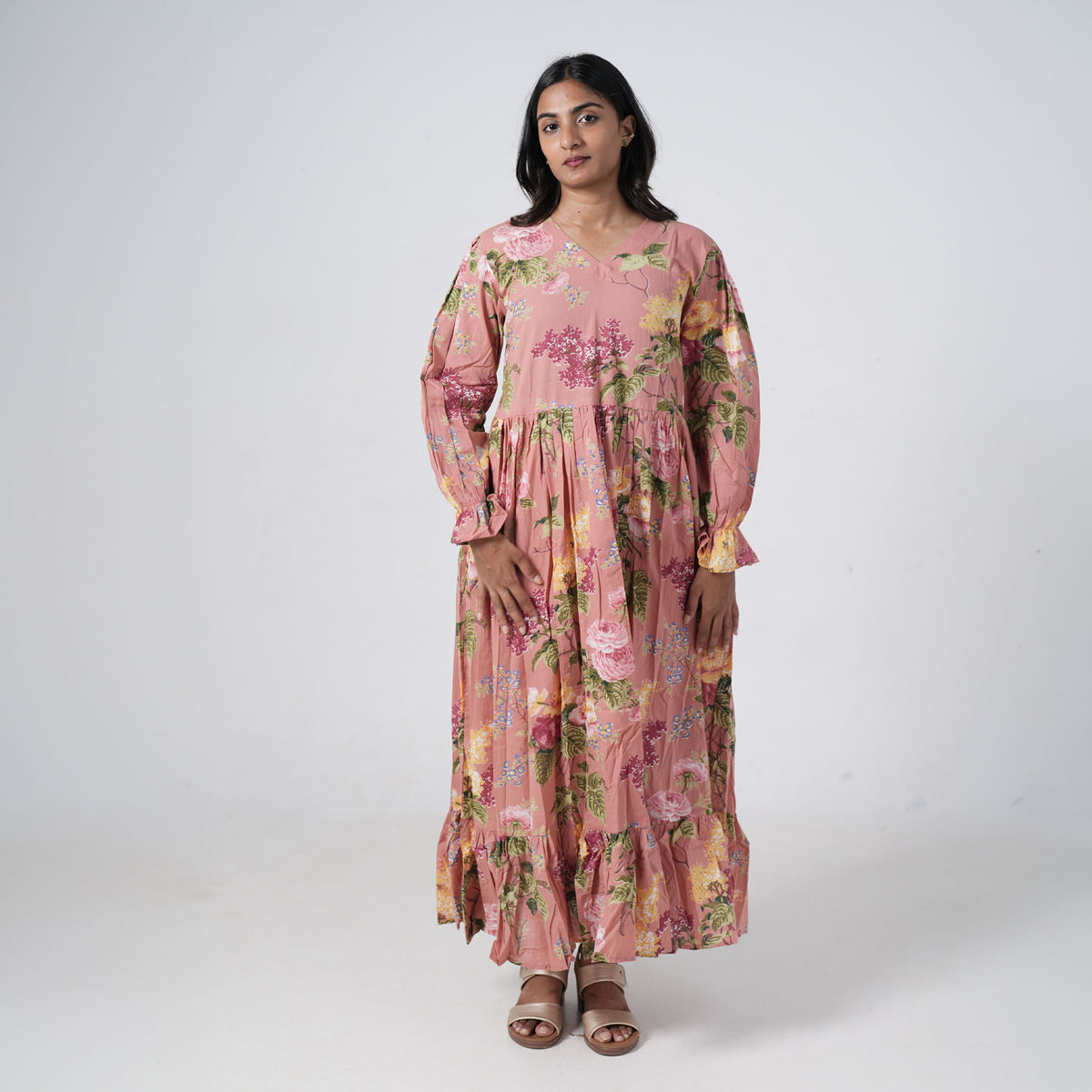 Inaya Long Kurti for women featuring a dusty pink base, multicolour floral prints, a V-neckline, long puff sleeves and a flared silhouette with a ruffled hem