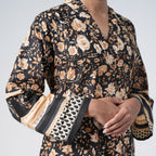 Kaala Rang black floral kurti with wide sleeves and beige decorative borders