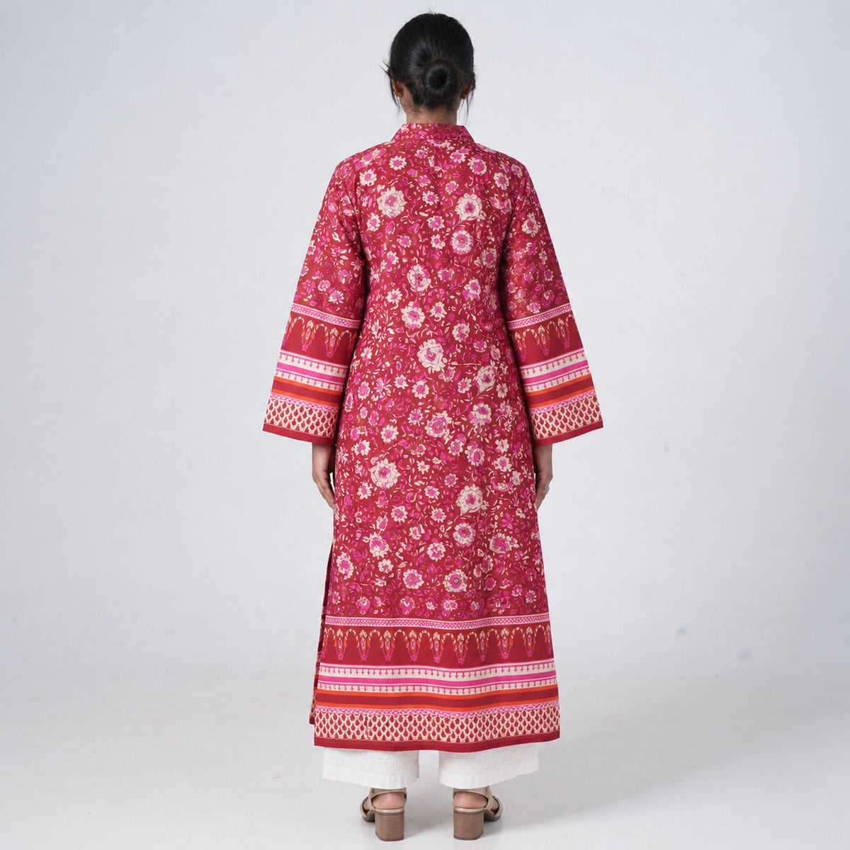 Back view of Laal Rang Long Kurti featuring deep red fabric, floral prints and decorative border patterns
