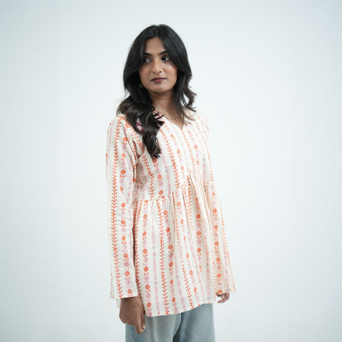 Mogra flared kurti featuring a V neckline with delicate orange and pink prints