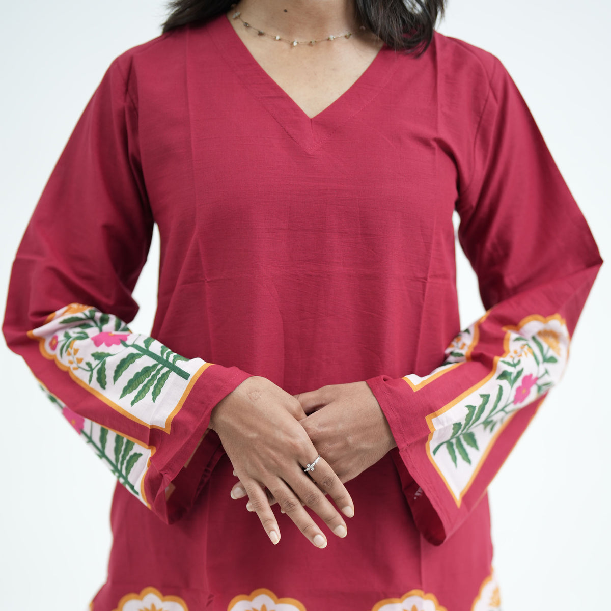 Mughal Knee Kurti featuring long flared sleeves with colourful floral border prints on maroon fabric