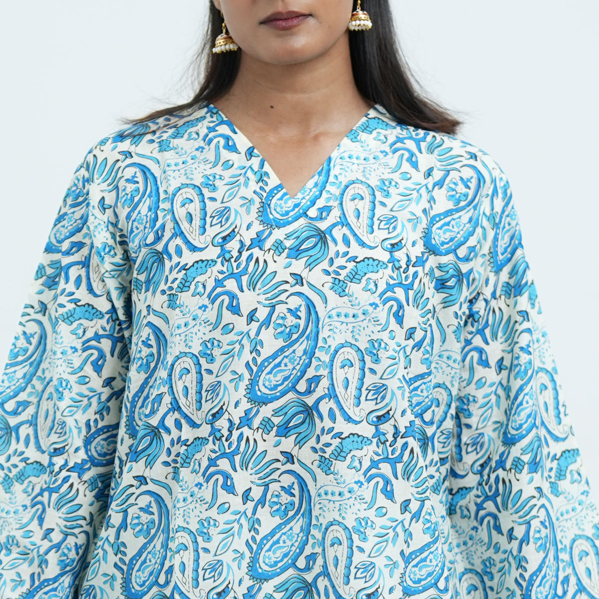 Neelam Noor Short Kurti featuring a V neckline and blue paisley patterns on a white background