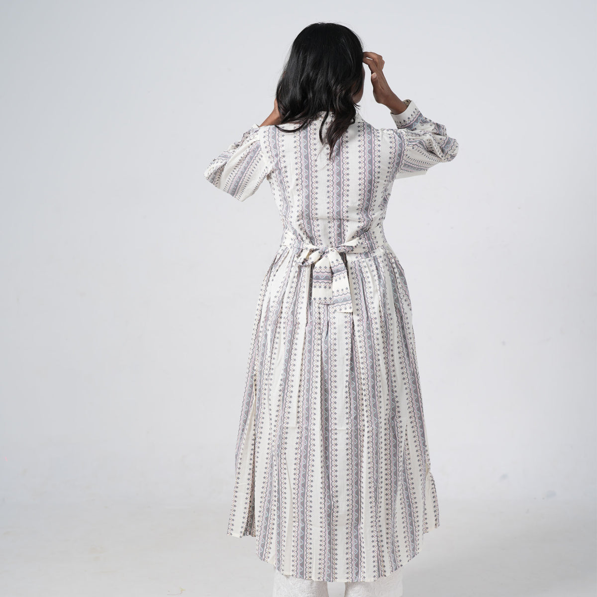 Back view of Pearl Long Kurti featuring vertical grey and mauve geometric prints on an ivory base