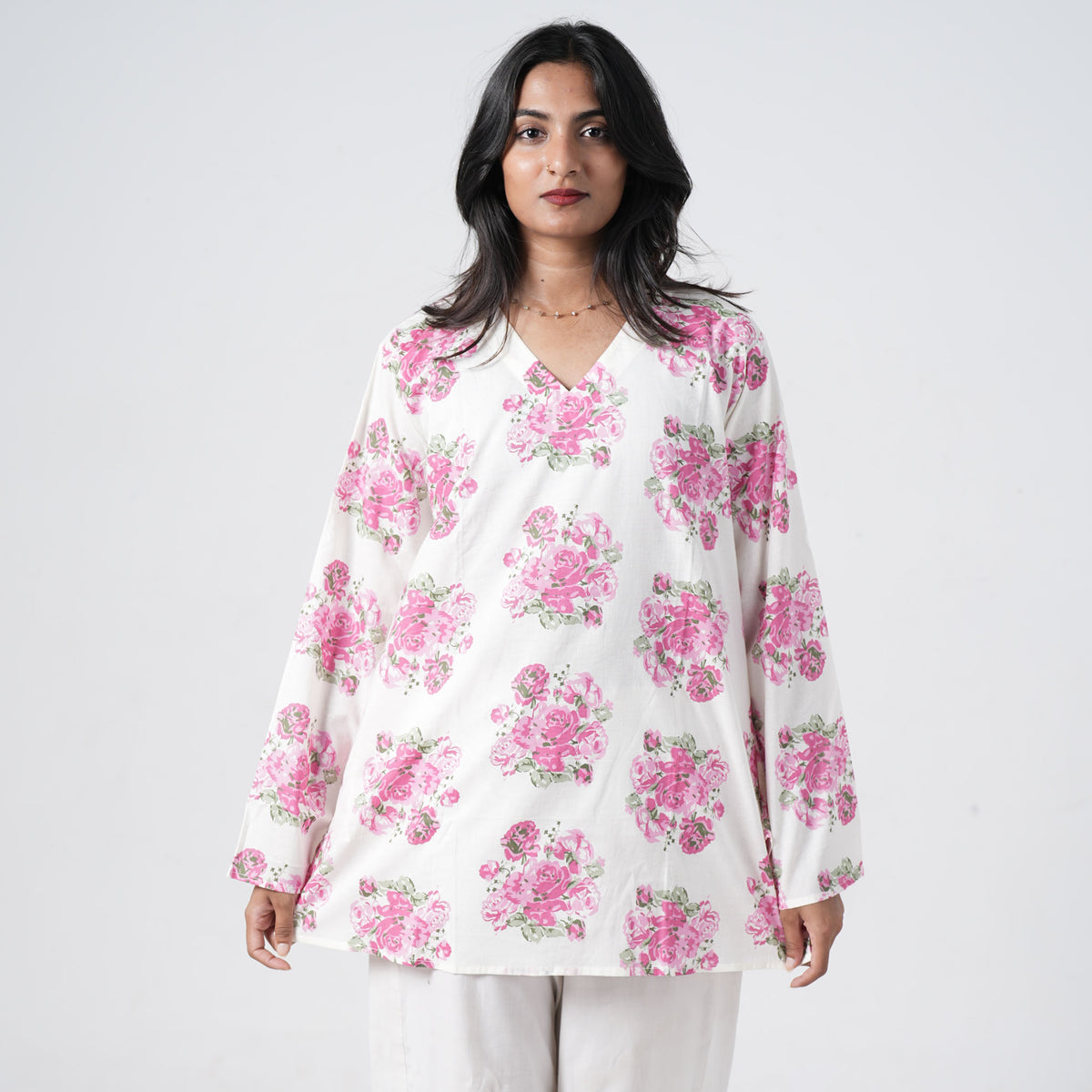 Pink floral short kurti for women with pink rose prints on a white base