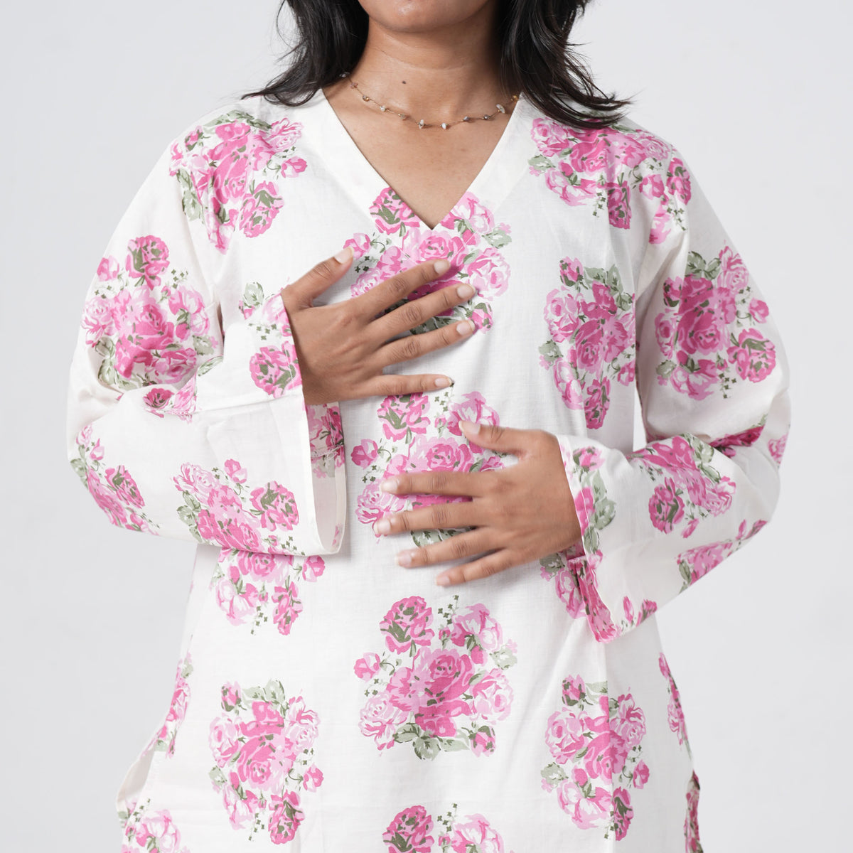 Pink floral short kurti featuring a V neckline and pink rose patterns