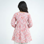 Back view of Rosette Umbrella Kurti with pink, coral and grey floral prints on an ivory base