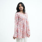 Rosette Umbrella Kurti for women featuring pink, coral and grey floral prints on an ivory base with a flared silhouette