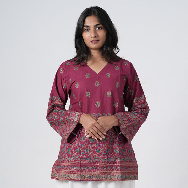 Ruby Short Kurti for women in ruby pink with small floral motifs, a V neckline and decorative multicolour border prints