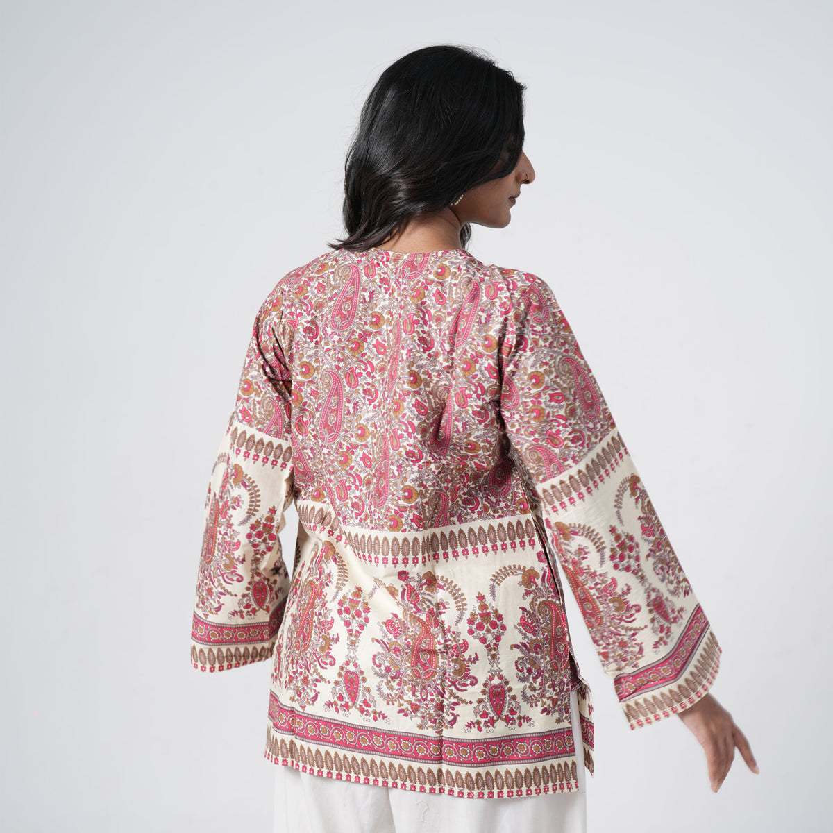 Back view of Ruhani Short Kurti featuring cream fabric with red and brown paisley prints and decorative borders