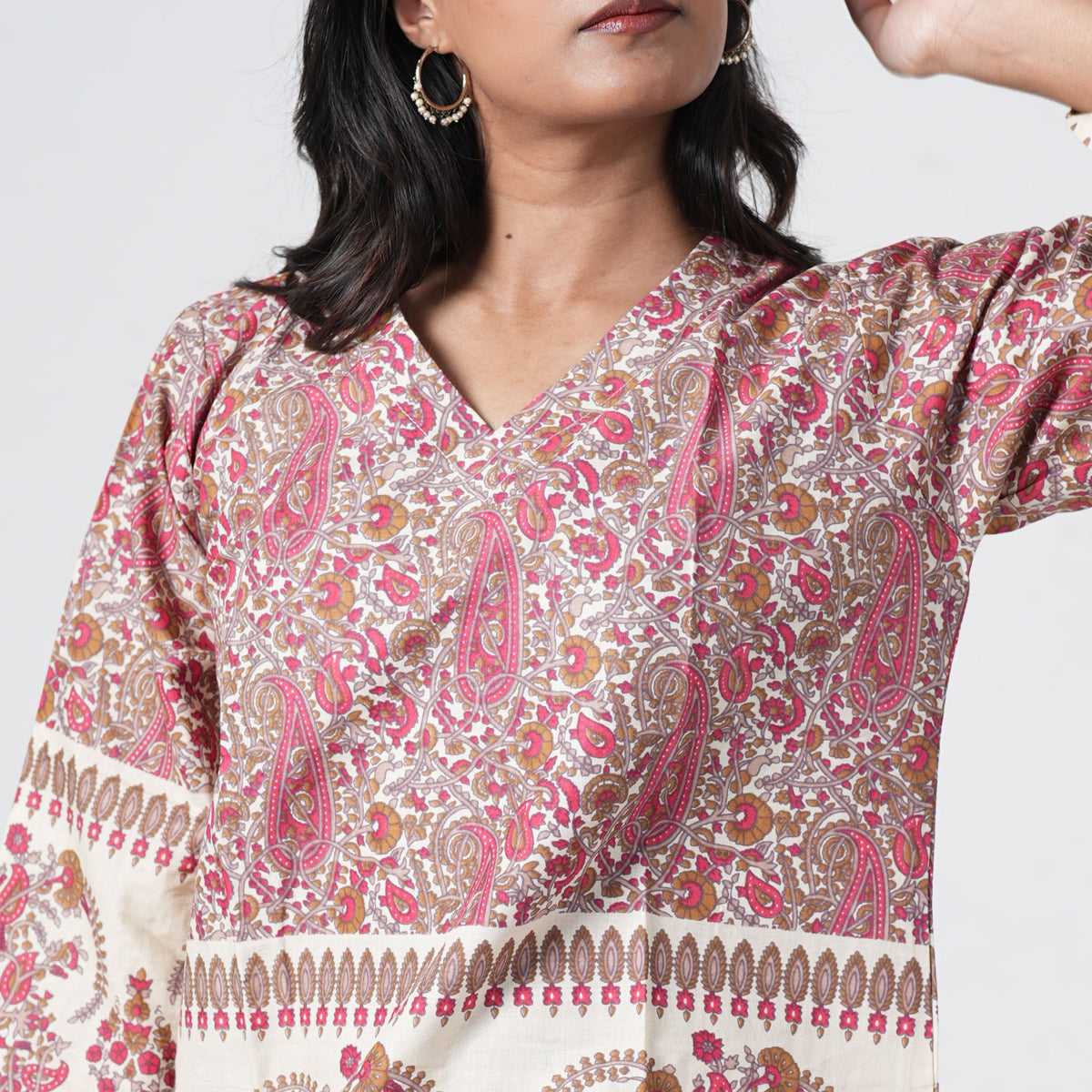 Ruhani Short Kurti with a V neckline and intricate red and brown paisley prints on cream fabric