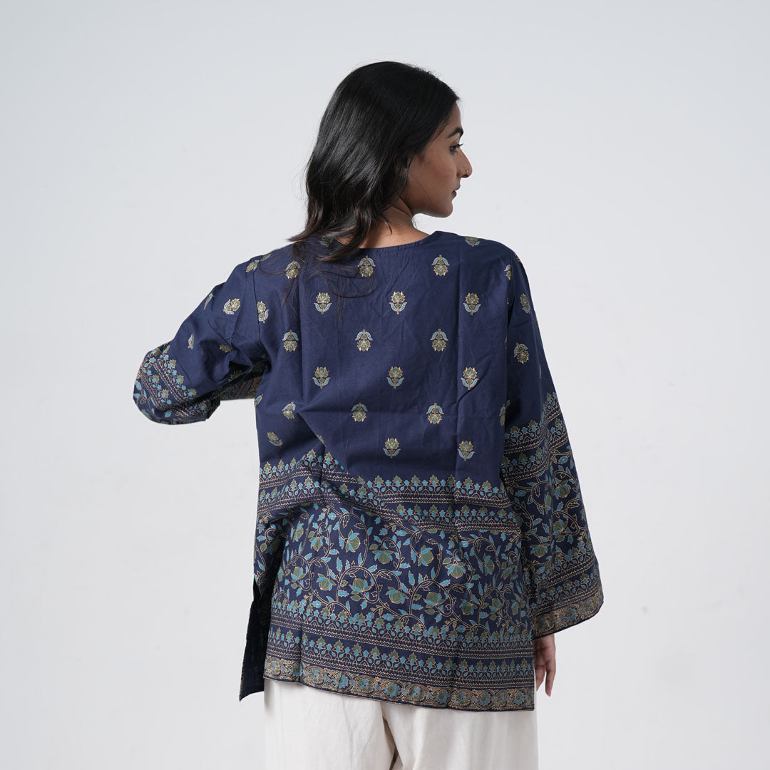 Back view of sapphire blue short kurti with floral motifs and decorative borders