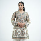 Sukoon knee length printed kurti for women with green and brown paisley patterns on a cream base