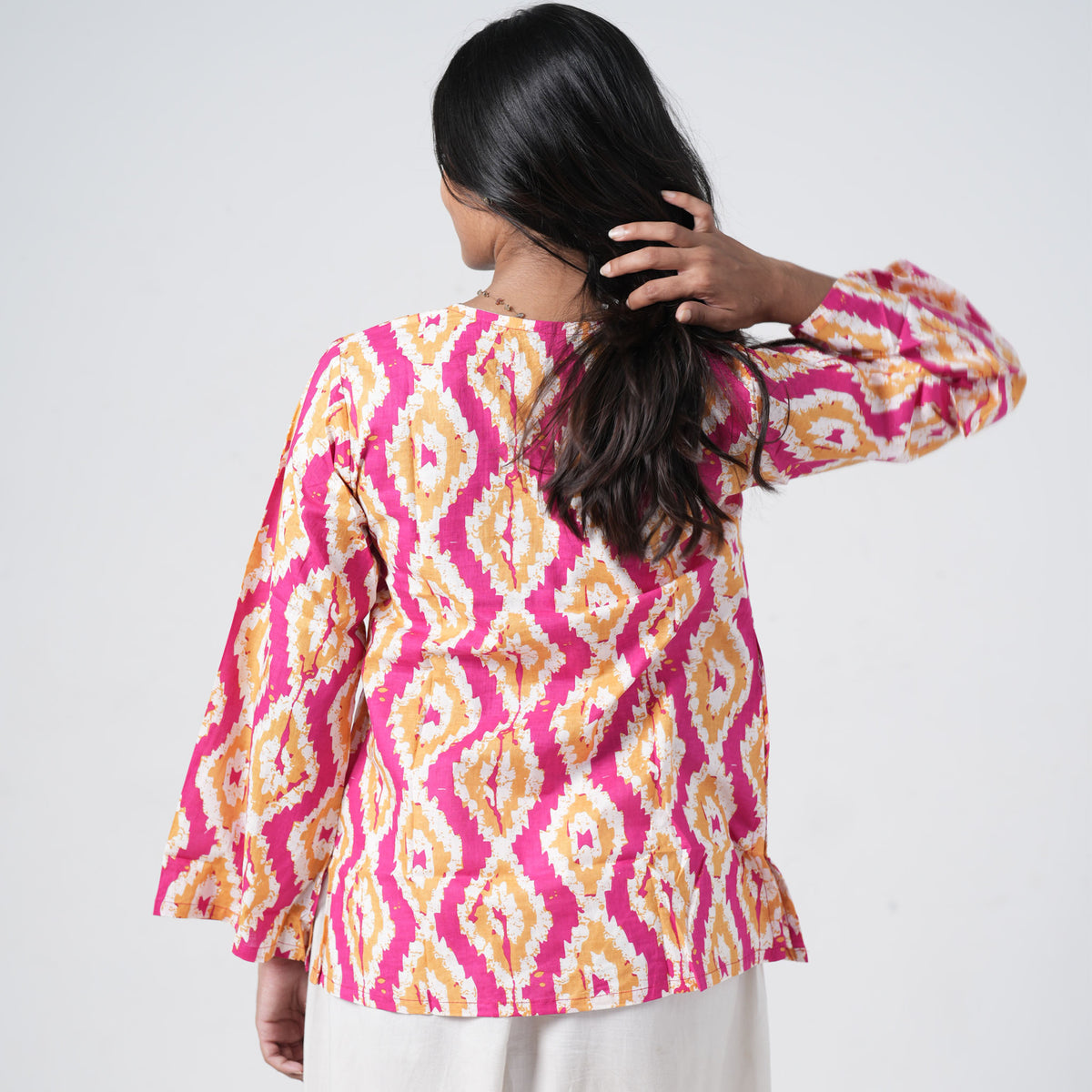 Back view of Sunset printed short kurti with pink and mustard geometric patterns