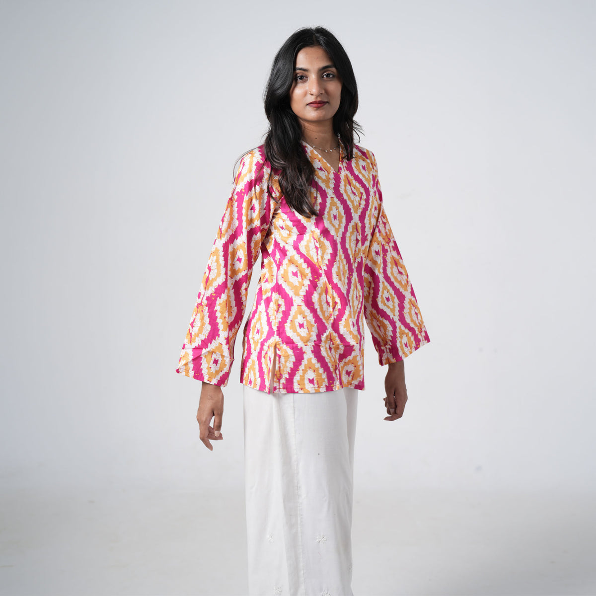 Sunset printed short kurti featuring a V neckline and bold geometric patterns