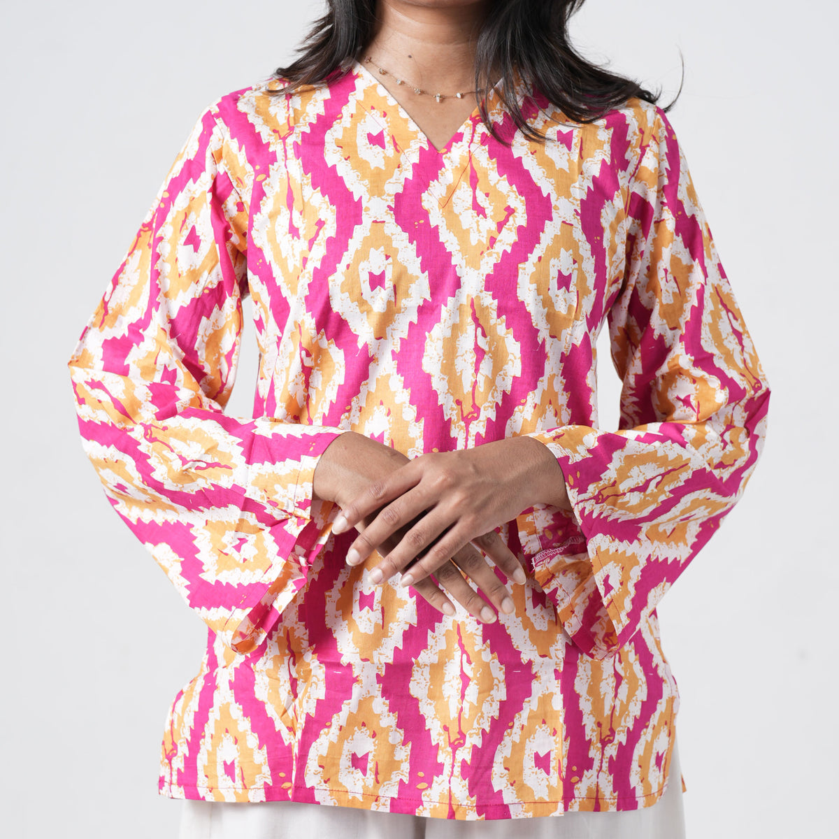 Sunset printed short kurti with long sleeves and pink mustard geometric prints