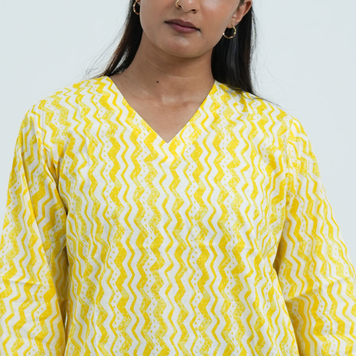 Yellow Short Kurti with a V neckline and a bright yellow and white geometric print