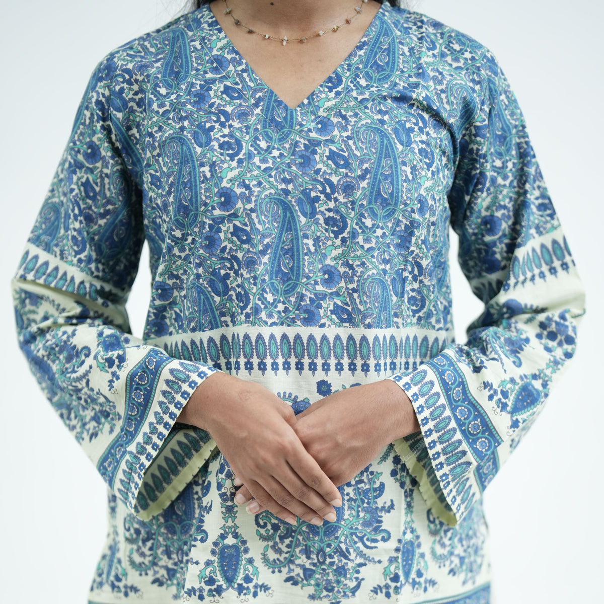 Zareen blue short kurti with long sleeves and decorative printed borders