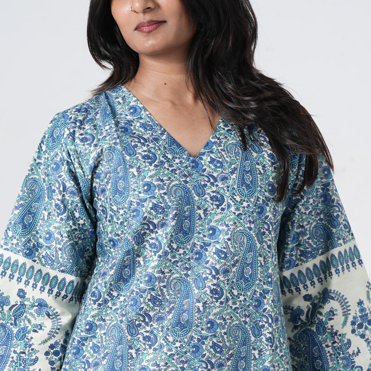 Zareen Knee Kurti with a V neckline and intricate blue paisley patterns on cream fabric